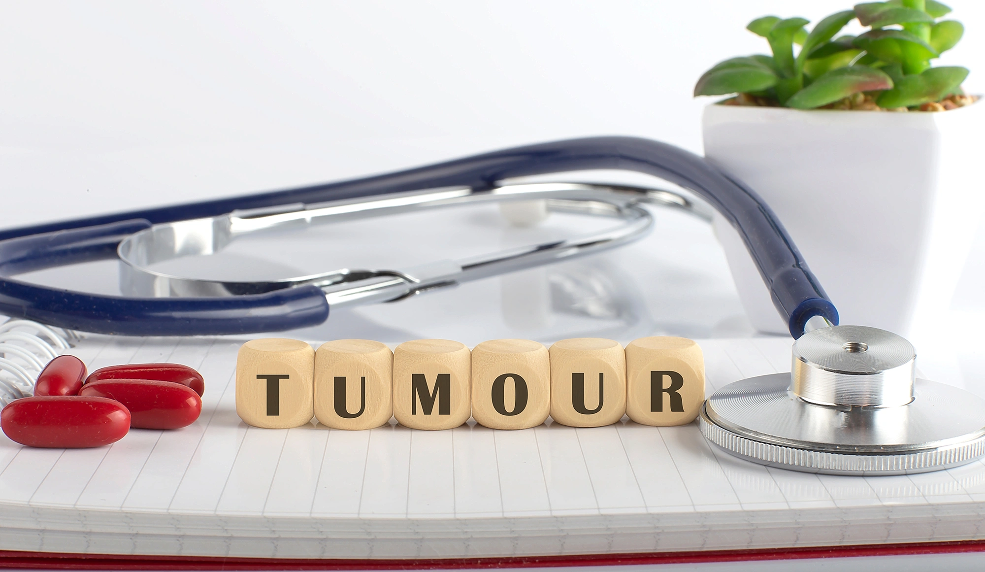 Building blocks spelling out the word “tumour”.